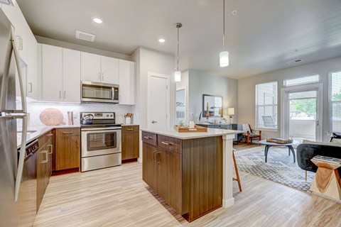 A modern kitchen with wooden cabinets and a central island.